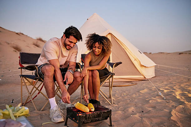 istock Couple camping in desert grilling corn on barbecue 2252725791