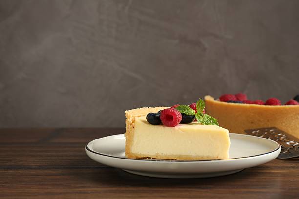 istock Delicious cheesecake with fresh berries and mint served on wooden table, space for text 2252726359