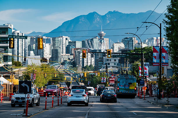 Cars stand at a stop light on Cambie Street, downtown Vancouver BC Canada, on a sunny day.