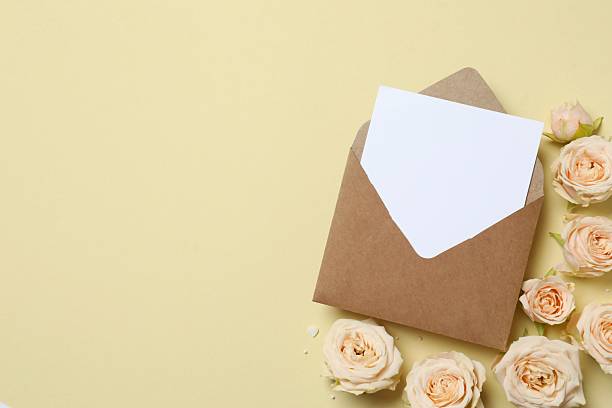 istock Beautiful composition with peony roses and paper envelope on color background 2252726533