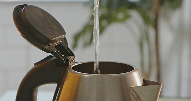 istock Water Pouring into Open Electric Kettle 2252726735