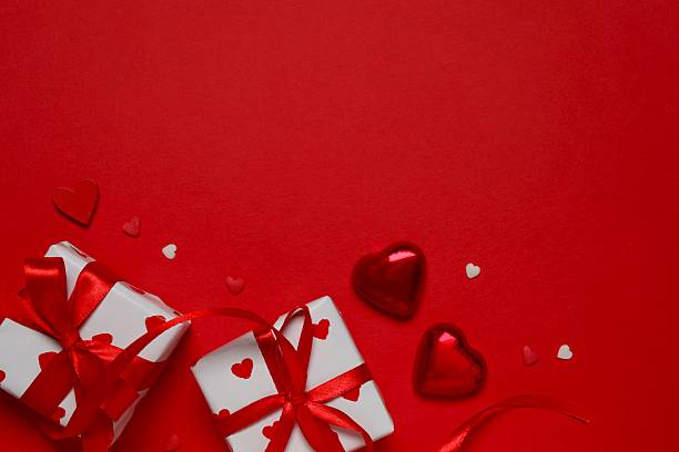 istock Gift boxes with red hearts on color background 2252726833