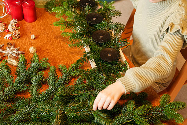 istock Child arranging advent wreath with candles and pine branches 2252727161
