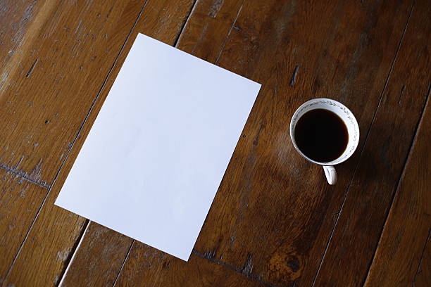 istock A4 Paper and Frame on Wood Table with Coffee Mock up 2252727448