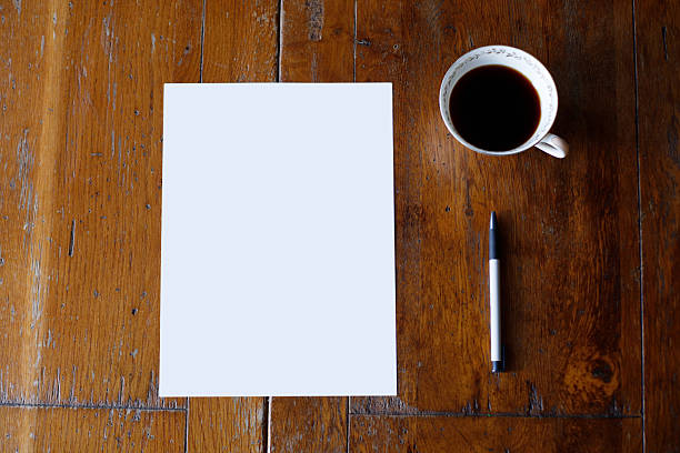 istock A4 Paper and Frame on Wood Table with Coffee Mock up 2252727450