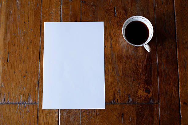 istock A4 Paper and Frame on Wood Table with Coffee Mock up 2252727454