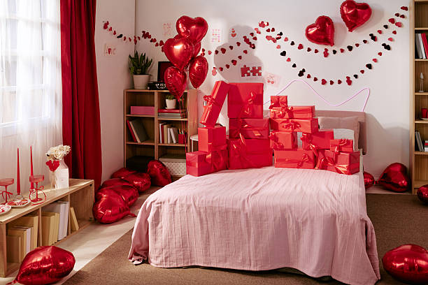 istock Valentines Day Balloons and Gift Boxes Arranging on Bed in Decorated Room 2252728424