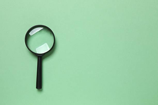 istock Magnifying glass on color background 2252728571