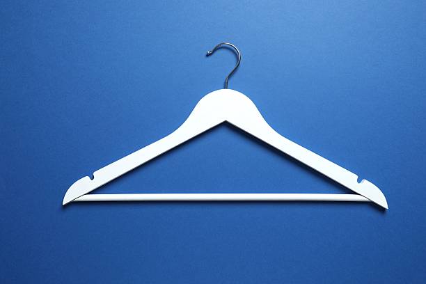 istock Wooden clothes hanger on a colored background 2252731011