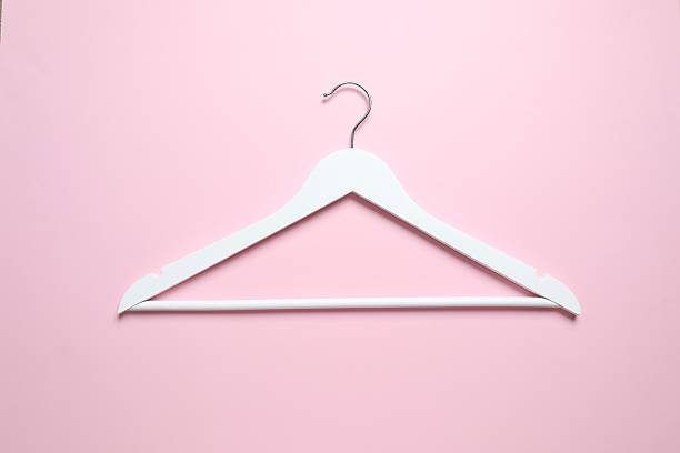 istock Wooden clothes hanger on a colored background 2252731024