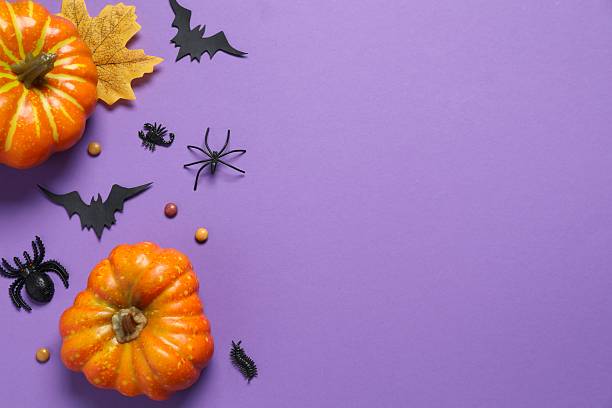 istock Halloween holiday decorations including pumpkins, spiders, bats on color background 2252732397