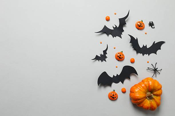 istock Halloween holiday decorations including pumpkins, spiders, bats on grey background 2252732444