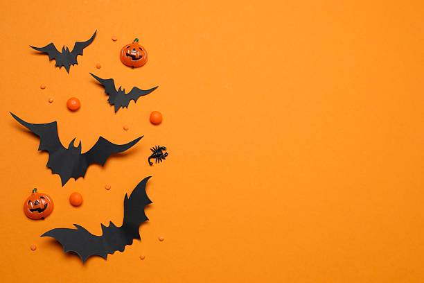 istock Halloween holiday decorations including pumpkins, spiders, bats on orange background 2252732474