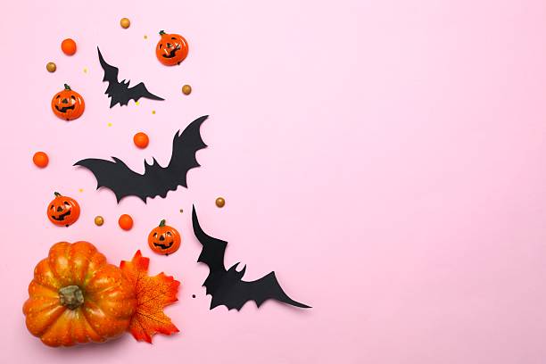 istock Halloween holiday decorations including pumpkins, spiders, bats on color background 2252732514