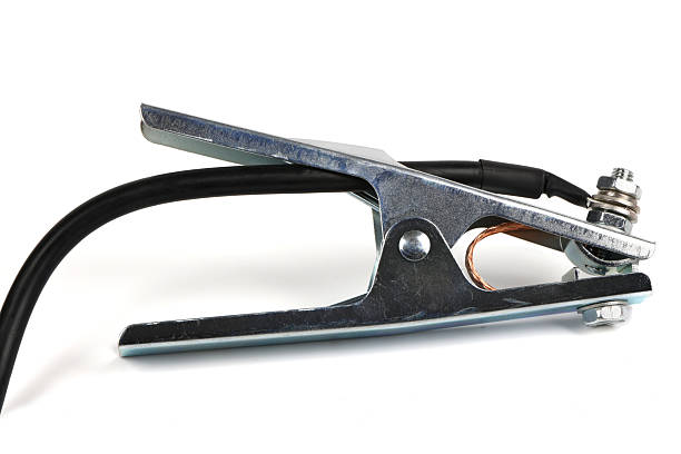 Chrome-plated welding ground (earth) clamp with a black cable attached. Spring-loaded metal clip for electrical grounding isolated on white.