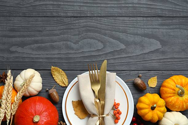 istock Rustic holiday table setup. Top view with plates, cutlery and autumn decorations. Empty space for your text 2252734373