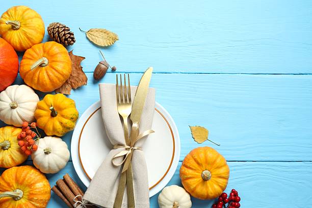 istock Rustic holiday table setup. Top view with plates, cutlery and autumn decorations. Empty space for your text 2252734378