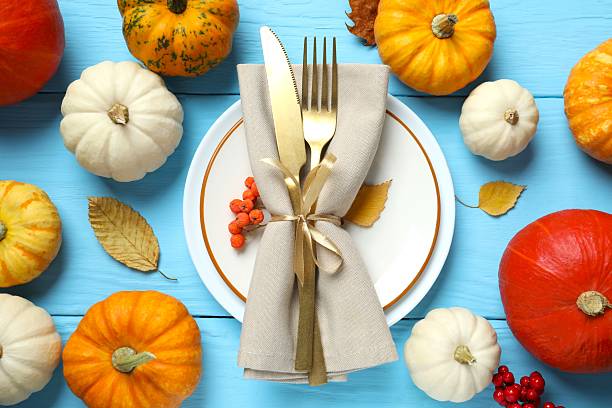 istock Rustic holiday table setup. Top view with plates, cutlery and autumn decorations. Empty space for your text 2252734392