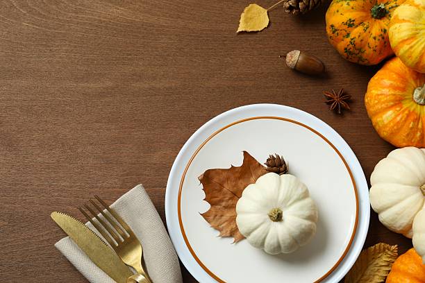 istock Rustic holiday table setup. Top view with plates, cutlery and autumn decorations. Empty space for your text 2252734547