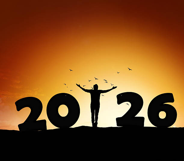 istock 2026 New Year Silhouette Celebration with Person Standing Between Numbers at Sunset 2252735611