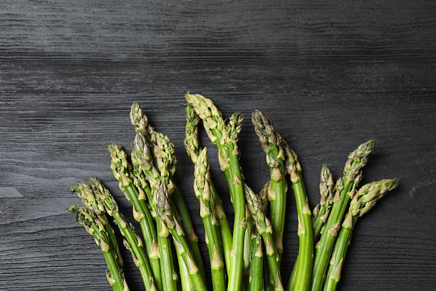 istock Fresh green asparagus on wooden background 2252737674