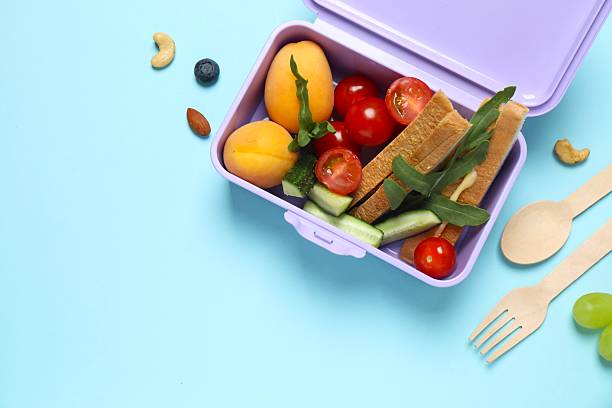 istock Packed lunch with sandwiches, fruits, nuts and vegetables in a divided container 2252737961