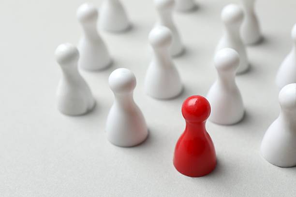 istock Group of pawns on the table. Concept of unity 2252738594