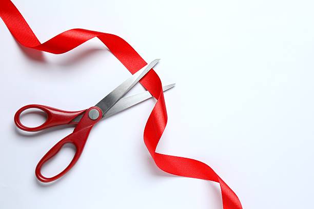 istock Stylish scissors and red ribbon on white background, flat lay with space for text. Ceremonial tape cutting 2252738964