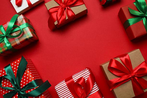 istock Beautiful gift boxes tied with bows on red background 2252739081