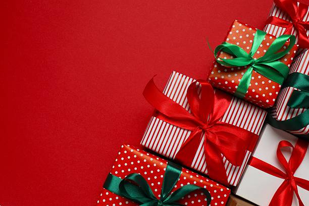 istock Beautiful gift boxes tied with bows on red background 2252739093