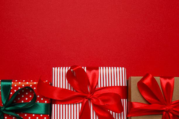 istock Beautiful gift boxes tied with bows on color background 2252739095
