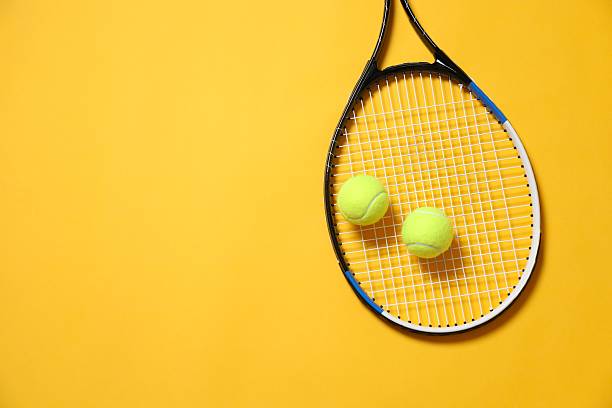 istock Tennis racket and balls on color background 2252739724