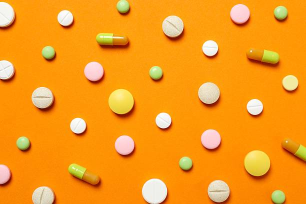 istock Various medical pills on a colored background 2252739972