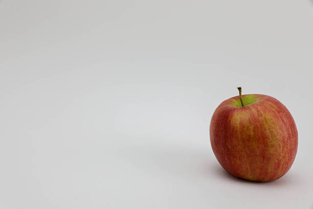 Fresh Red Apple Standing On A White Background, Highlighting Its Natural Color, Healthy Appearance, And Nutritional Symbolism, Ideal For Concepts Related To Wellness, Diet, And Organic Food.