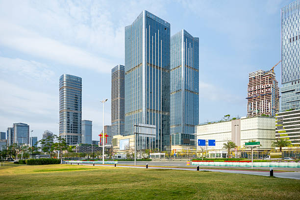 A contemporary cityscape featuring towering skyscrapers amidst lush greenery, showcasing urban development and nature coexistence. The scene captures the blend of architectural grandeur and serene environment, ideal for real estate promotions or urban planning concepts.
