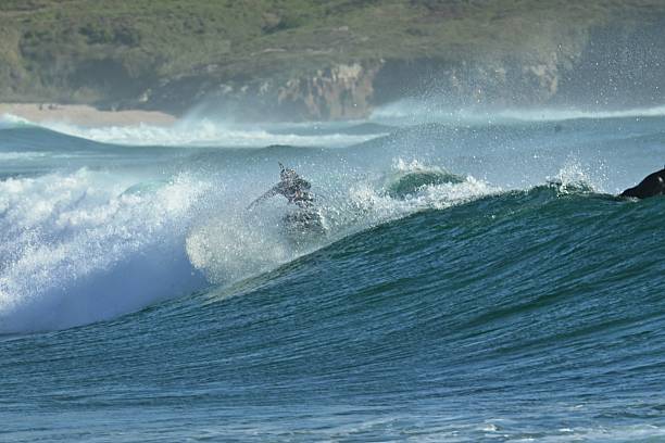 istock Surfer riding big ocean waves 2252747632