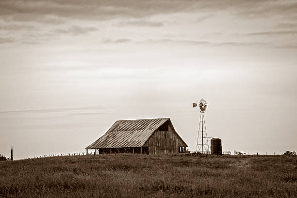 istock Rural barn and windmill on open farmland landscape 2252751577