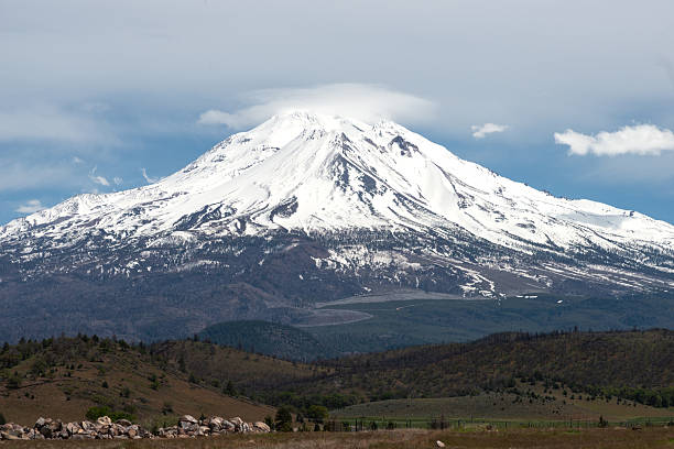 Beautiful scenic Mt Shasta covered in snow with minimal clouds.