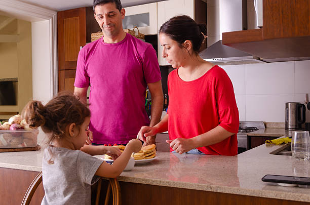 Domestic family life scene in the kitchen.