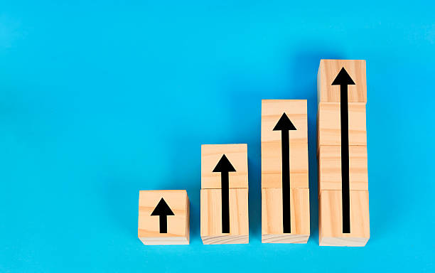 istock A visual concept of rising performance illustrated by blocks arranged as ascending steps with upward arrows symbolizing progress and strategic advancement. 2252760966