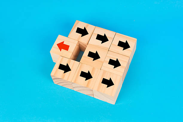 istock A disruption and originality concept showing a single reversed arrow among aligned forward arrows to symbolize unique thinking and unconventional direction. 2252760986