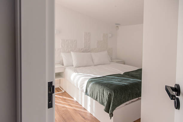 istock Soft daylight filters through curtains into a cozy bedroom with a neatly made double bed, white linens and pillows, creating a calm, inviting space for rest and relaxation in a modern home. 2252761027