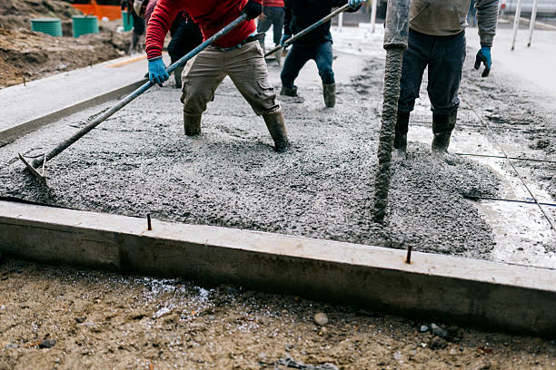 Men Work Pouring Concrete Slab At Home Build