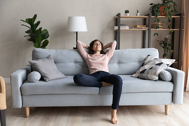 istock Peaceful happy young woman relaxing on comfortable sofa. 2252769147