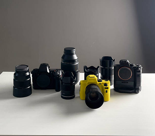 istock Various cameras and lenses arranged neatly on a table with a simple gray backdrop 2252772778