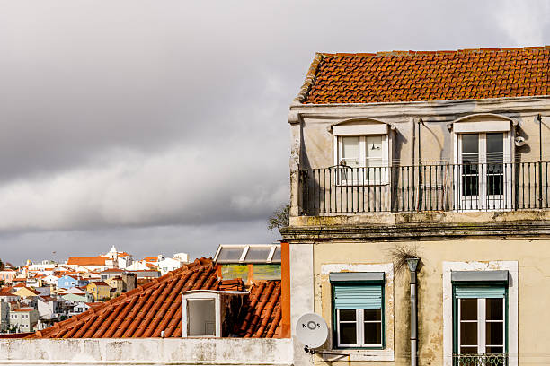 Lisbon Portugal December 05 2025. Close view of aging apartment facade with balconies and large mural painting in Alfama.