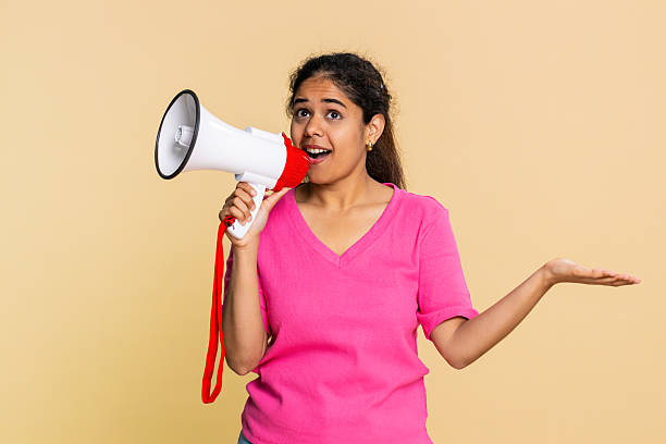 istock Indian woman energetically speaking into megaphone, making announcement or calling with excitement 2252775172