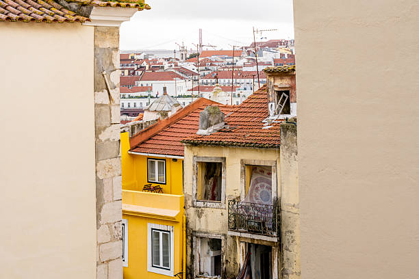 Lisbon Portugal December 05 2025. View between apartment buildings toward rooftops and dense urban housing in Alfama.