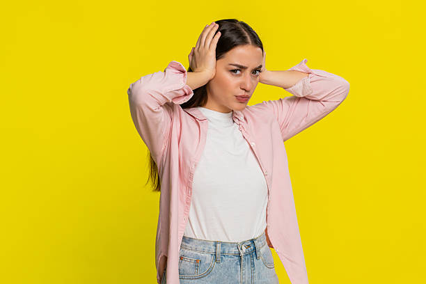 istock Woman covers ears with hands grimacing refusing to hear bad news avoiding unpleasant negative sound 2252779457
