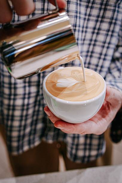 istock Barista Pouring Milk Creating Latte Art 2252779972